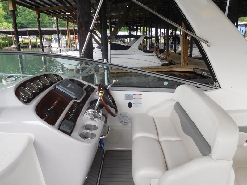 Slide: The Image of 2006 Chaparral 350 Signature boat cockpit with steering wheel and seating. - 21
