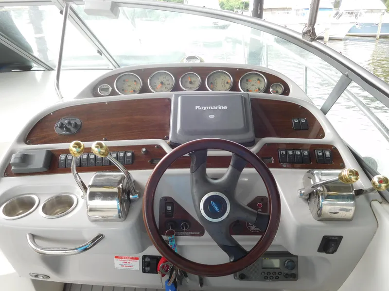 Slide: The Image of 2006 Chaparral 350 Signature boat helm with Raymarine navigation system and wooden dashboard. - 26