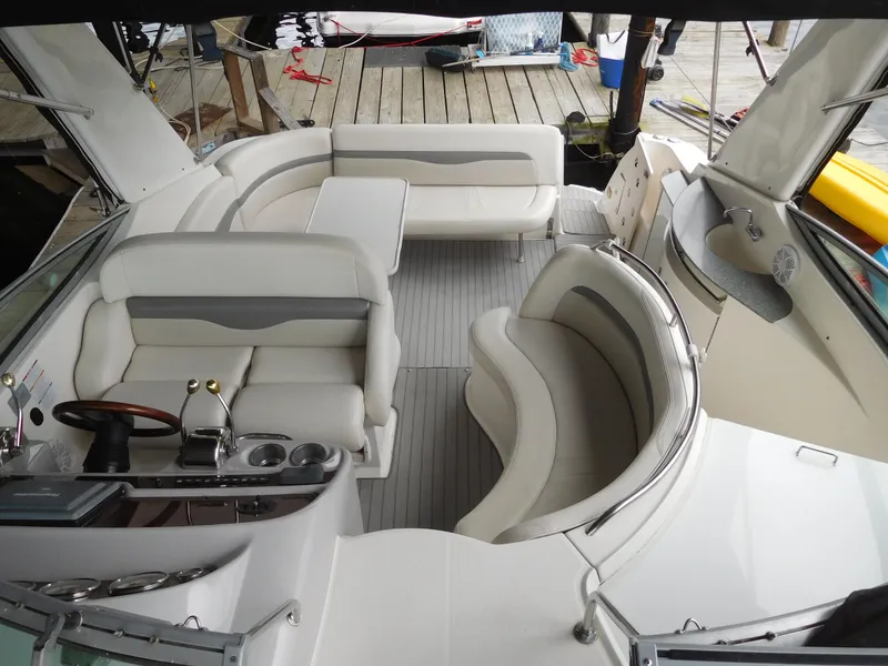 Slide: The Image of 2006 Chaparral 350 Signature boat interior with white leather seating and modern dashboard. - 29