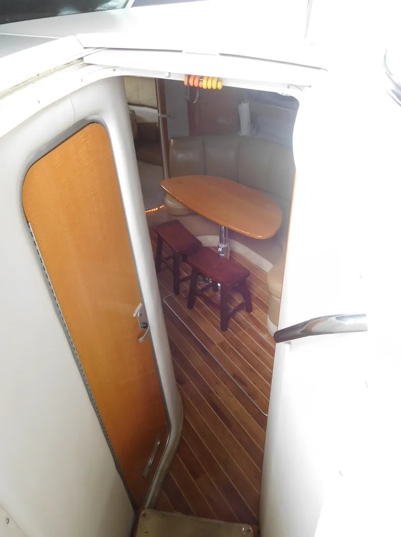 Slide: The Image of 2006 Chaparral 350 Signature cabin interior with wooden flooring and dining area. - 32