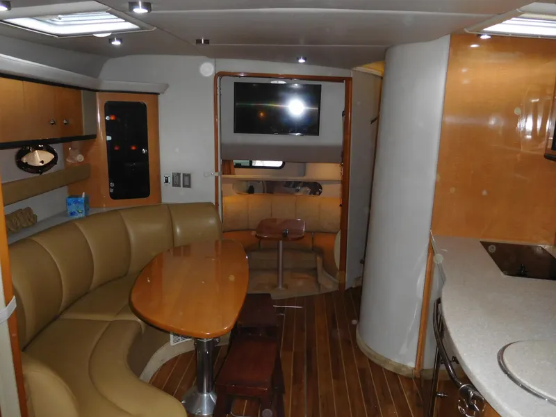 Slide: The Image of 2006 Chaparral 350 Signature yacht interior with dining area, TV, and kitchenette. - 34