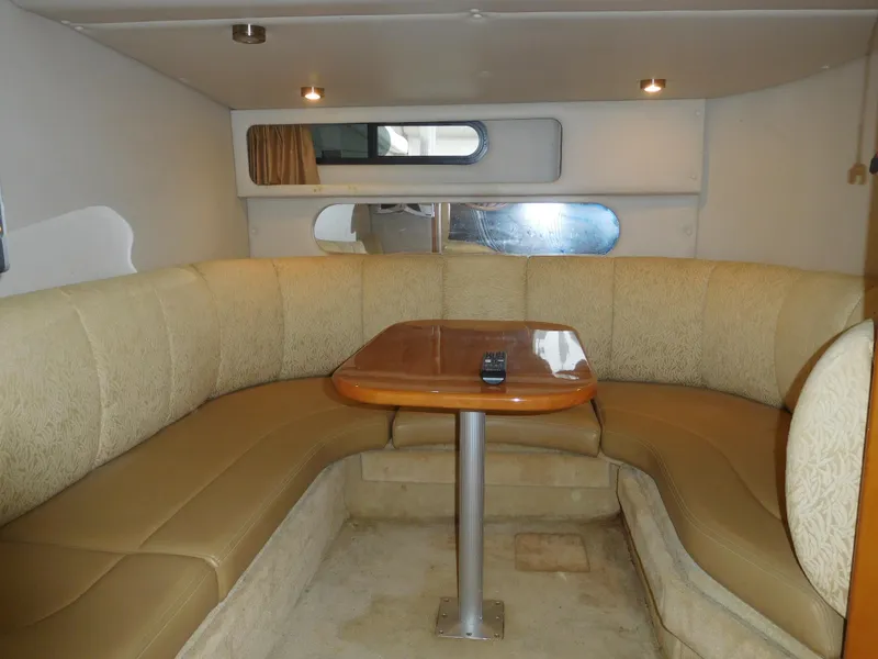 Slide: The Image of 2006 Chaparral 350 Signature boat interior with U-shaped seating and wooden table. - 36