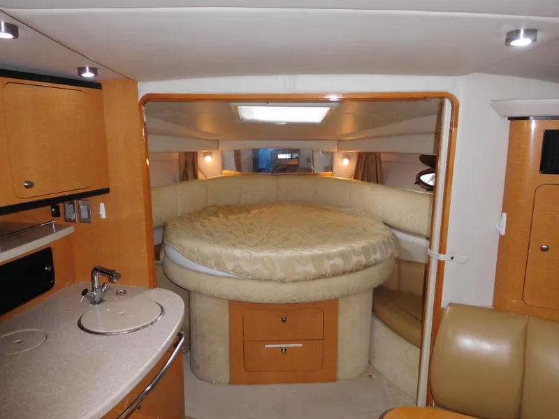Slide: The Image of Interior of 2006 Chaparral 350 Signature yacht with round bed and kitchenette. - 38