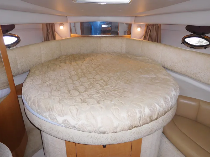 Slide: The Image of 2006 Chaparral 350 Signature boat interior with round bed and cozy lighting. - 39