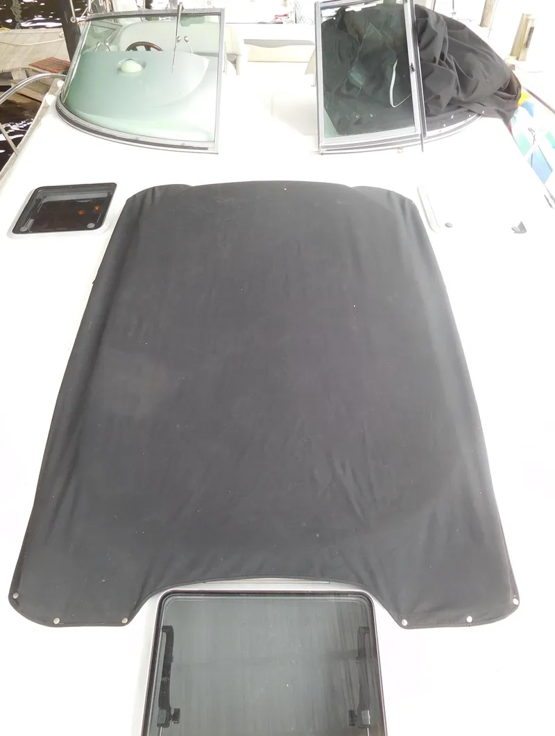 Slide: The Image of 2006 Chaparral 350 Signature boat deck with black cover and open hatches. - 6