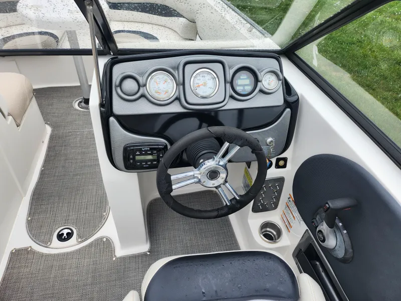 Slide: The Image of 2015 Starcraft Crossover 210 SCX IO boat dashboard and steering wheel. - 11