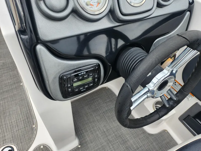 Slide: The Image of 2015 Starcraft Crossover 210 SCX IO boat dashboard with steering wheel and control panel. - 13