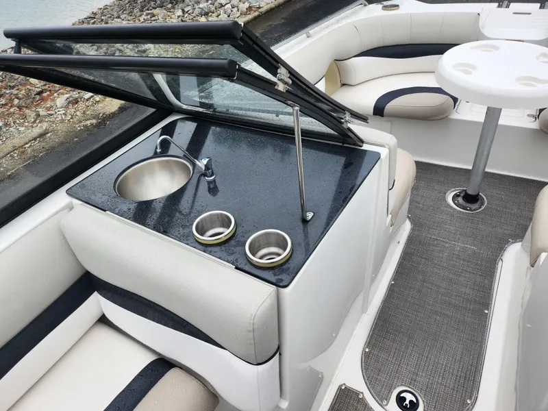 Slide: The Image of 2015 Starcraft Crossover 210 SCX IO boat interior with sink and seating area. - 14