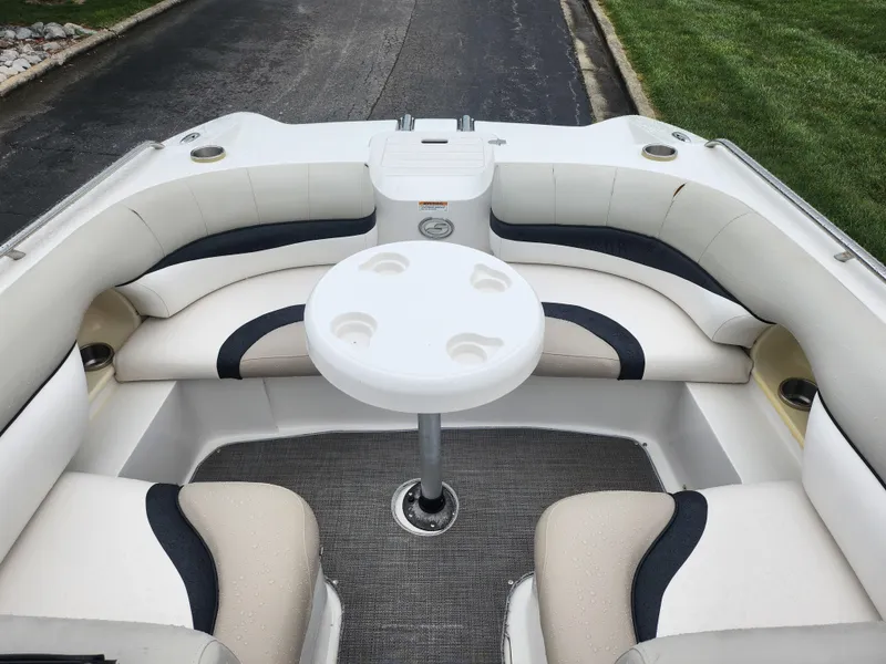 Slide: The Image of 2015 Starcraft Crossover 210 SCX IO boat interior with seating and table. - 15