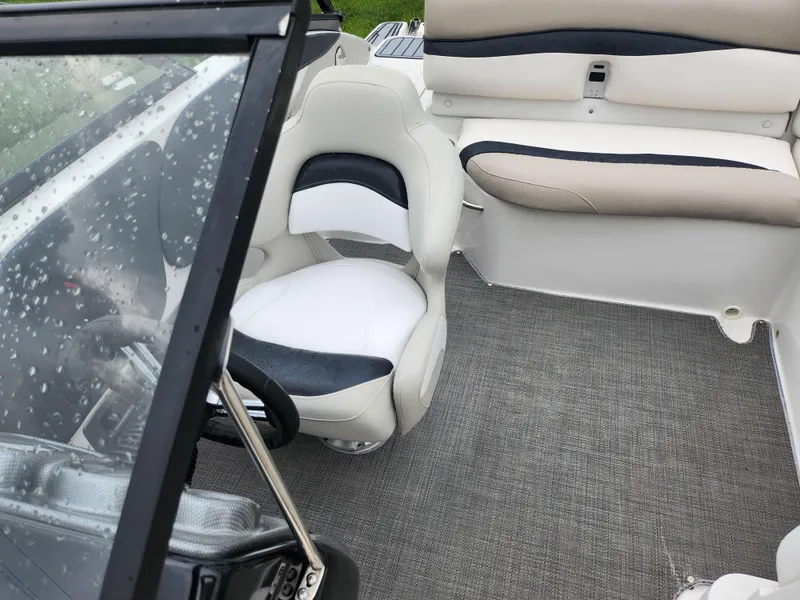 Slide: The Image of Interior of 2015 Starcraft Crossover 210 SCX IO boat with seating and steering wheel. - 18
