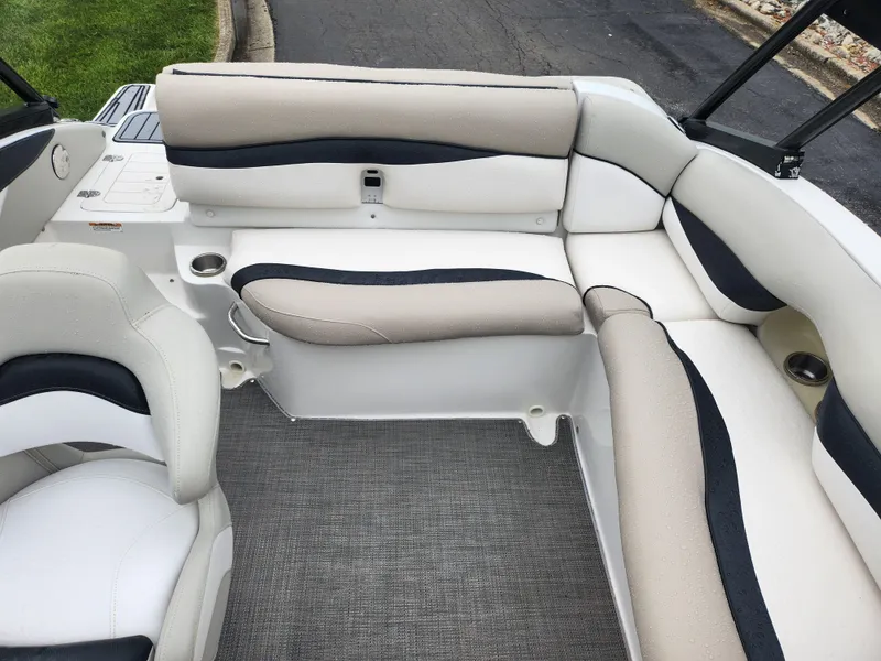 Slide: The Image of 2015 Starcraft Crossover 210 SCX IO boat interior with beige and black seating. - 19