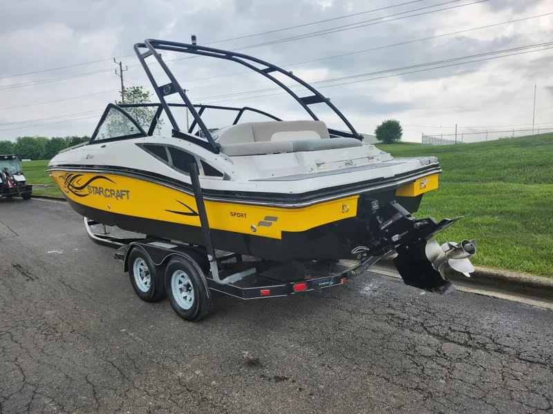Slide: The Image of 2015 Starcraft Crossover 210 SCX IO boat on trailer, yellow and white, rear view. - 3