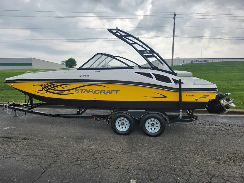 Slide: The Image of 2015 Starcraft Crossover 210 SCX IO boat on a trailer, yellow and white. - 4