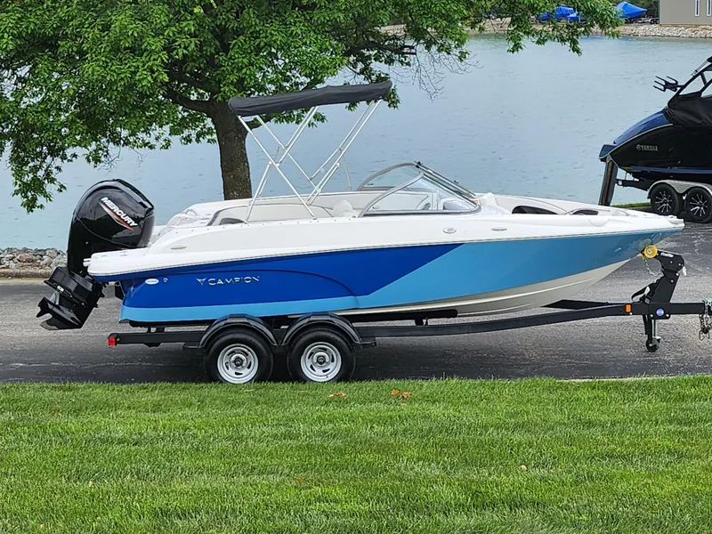 Slide: The Image of 2021 Campion Allante 20 Bowrider boat on a trailer by a lake. - 0