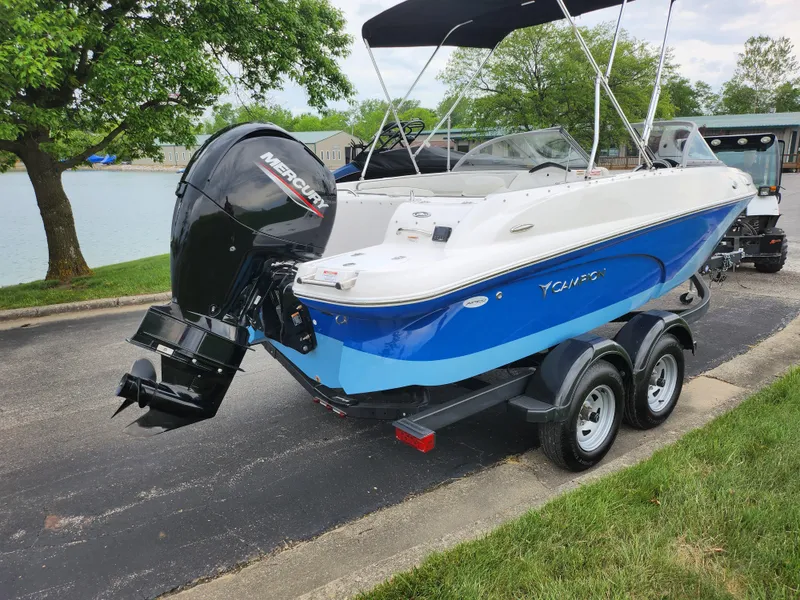 Slide: The Image of 2021 Campion Allante 20 Bowrider boat on a trailer by a lake. - 1