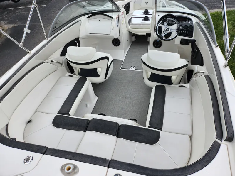 Slide: The Image of 2021 Campion Allante 20 Bowrider interior with white and black seating, steering console, and spacious layout. - 12