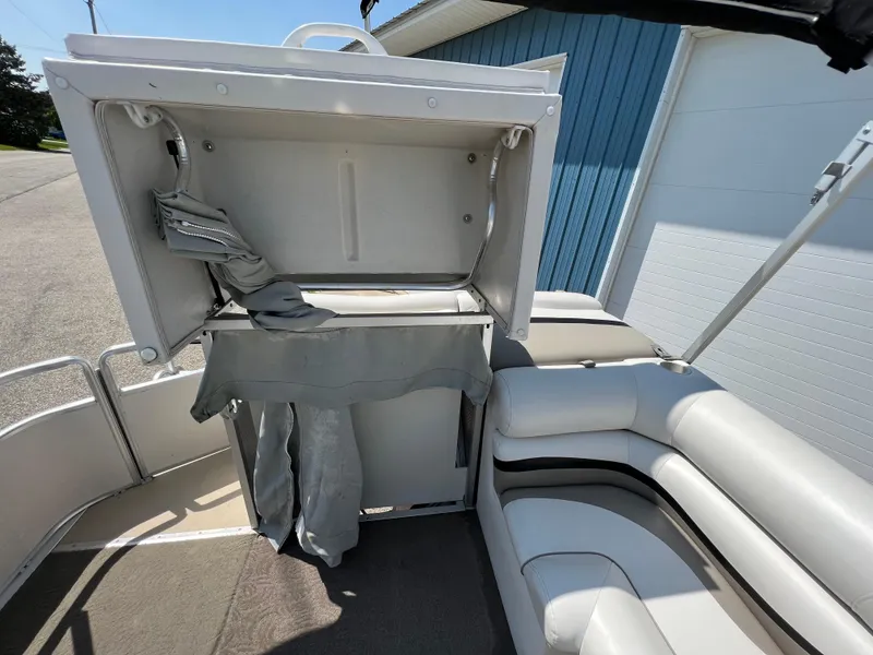 Slide: The Image of 2006 Harris FloteBote 250 Super Sunliner interior with open storage compartment. - 17
