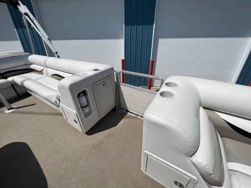 Slide: The Image of 2006 Harris FloteBote 250 Super Sunliner interior with white seating and cup holders. - 22