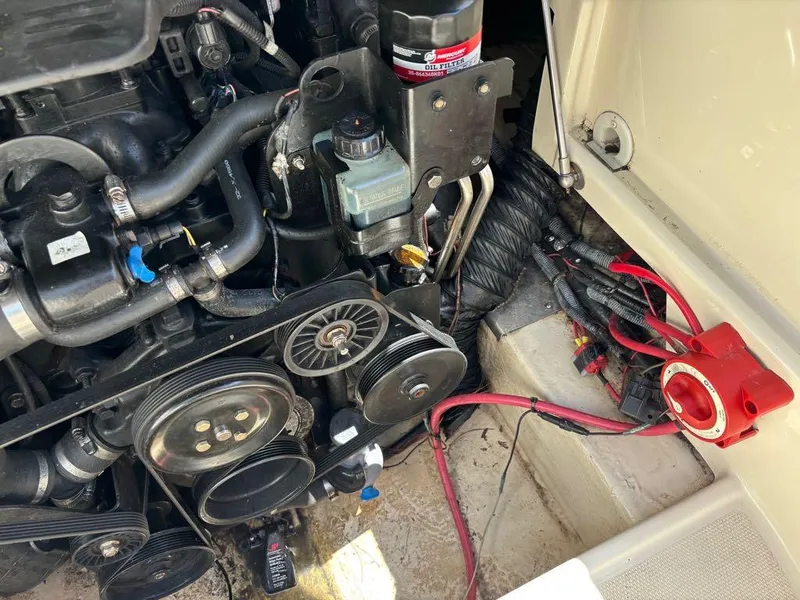 Slide: The Image of Close-up of a 2007 Azure AZ240 boat engine with visible belts and wiring. - 11