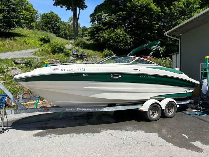 Slide: The Image of 2007 Azure AZ240 boat on a trailer in a scenic outdoor setting. - 13