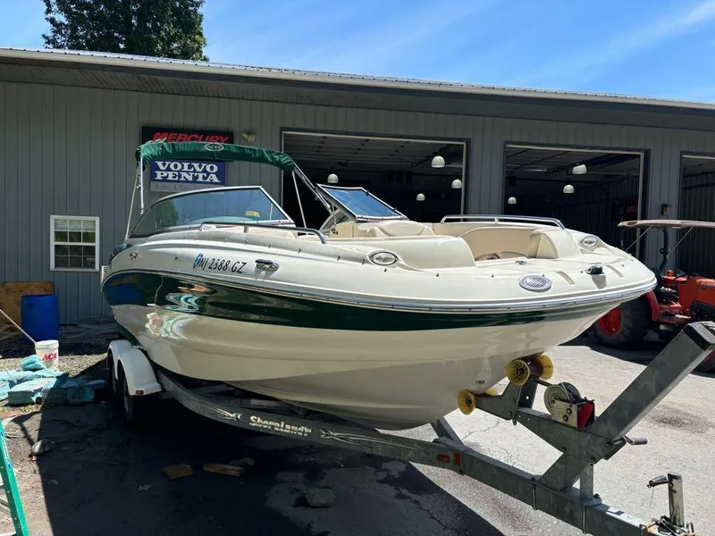 Slide: The Image of 2007 Azure AZ240 boat on trailer outside a garage. - 4