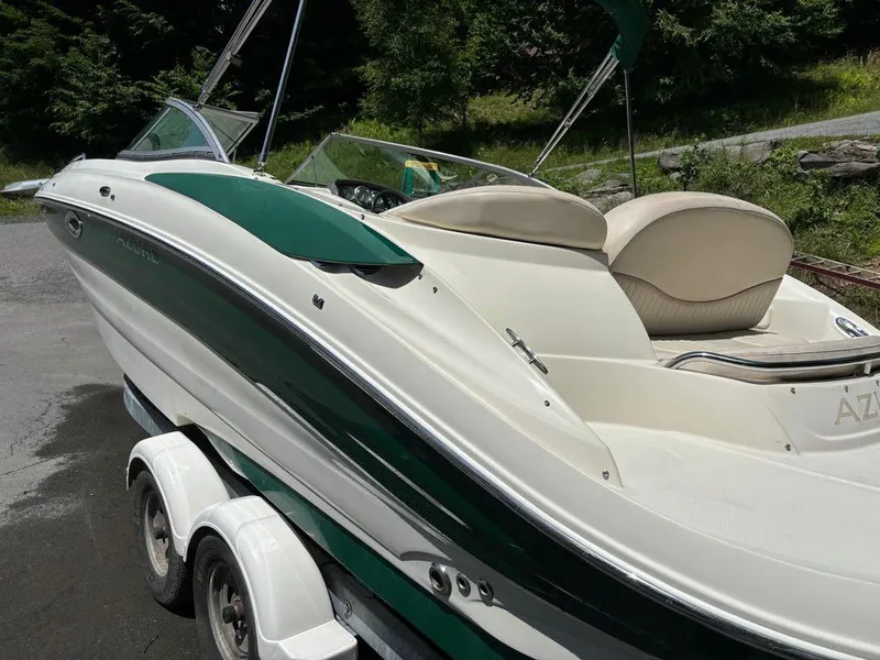 Slide: The Image of 2007 Azure AZ240 boat on a trailer, white and green exterior, parked outdoors. - 5