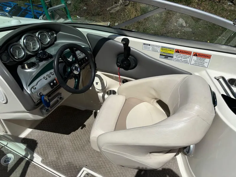 Slide: The Image of 2007 Azure AZ240 boat cockpit with steering wheel, gauges, and captain's chair. - 6