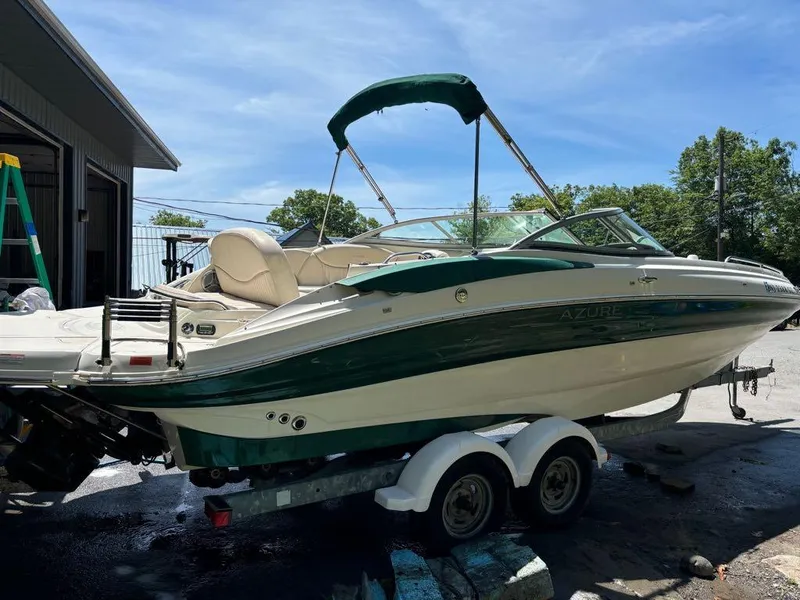 Slide: The Image of 2007 Azure AZ240 boat on trailer near garage. - 9