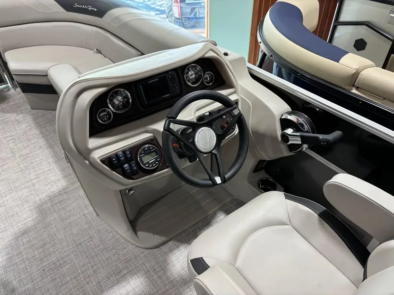 Slide: The Image of 2024 South Bay 200 Series S222CR2 boat interior, featuring steering console and seating. - 10