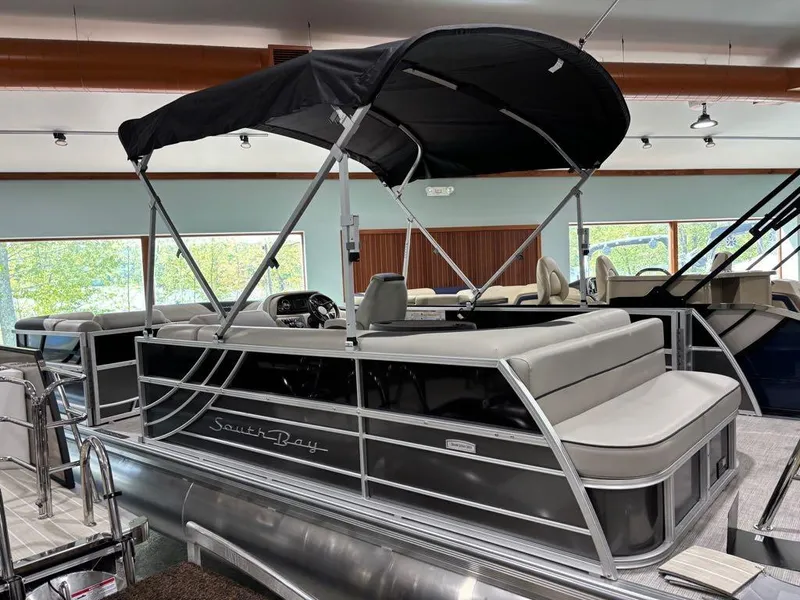 Slide: The Image of 2024 South Bay 200 Series S222CR2 pontoon boat with canopy in showroom. - 4