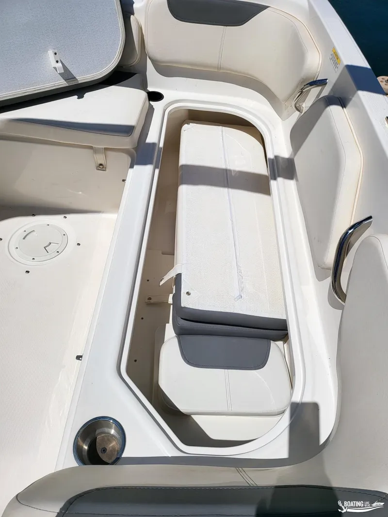 Slide: The Image of 2021 Bayliner E 21 boat interior storage compartment with cushioned seating. - 12