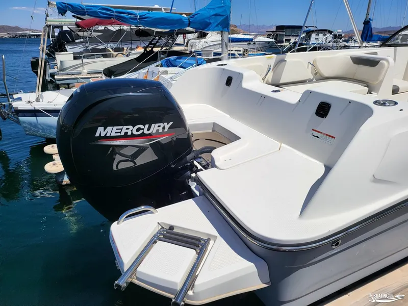Slide: The Image of 2021 Bayliner E 21 boat with Mercury outboard motor docked at marina. - 13