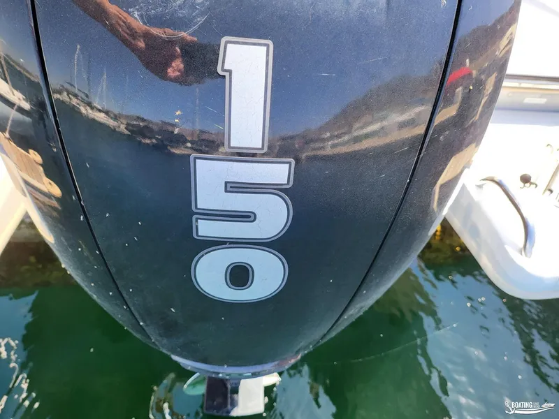Slide: The Image of Close-up of a 150 HP outboard motor on a 2021 Bayliner E 21 boat. - 14