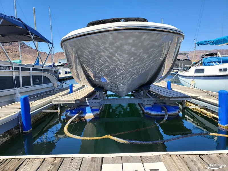 Slide: The Image of Bayliner E 21 2021 model boat docked at a marina with other boats. - 16
