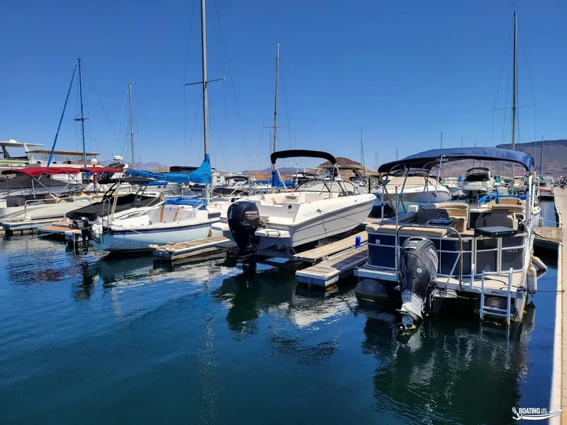 Slide: The Image of Boats docked at a marina, featuring a 2021 Bayliner E 21 model. - 17