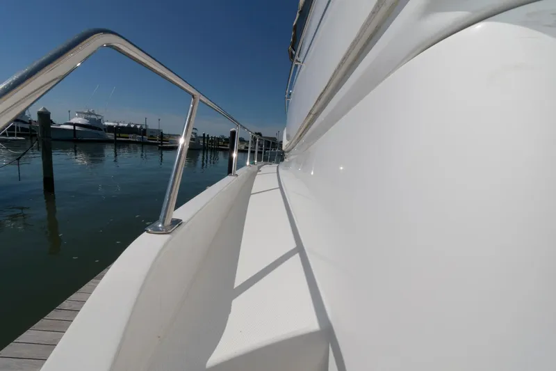 Slide: The Image of 2007 Carver 42 Super Sport yacht docked at a marina on a sunny day. - 13