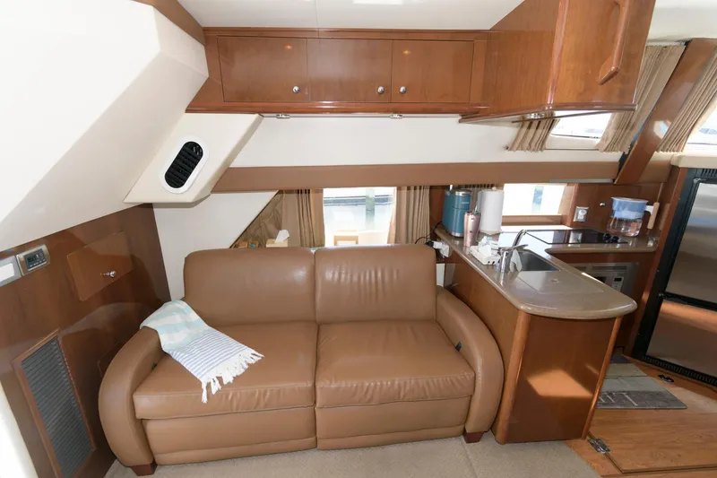 Slide: The Image of 2007 Carver 42 Super Sport yacht interior with leather sofa and kitchenette. - 15