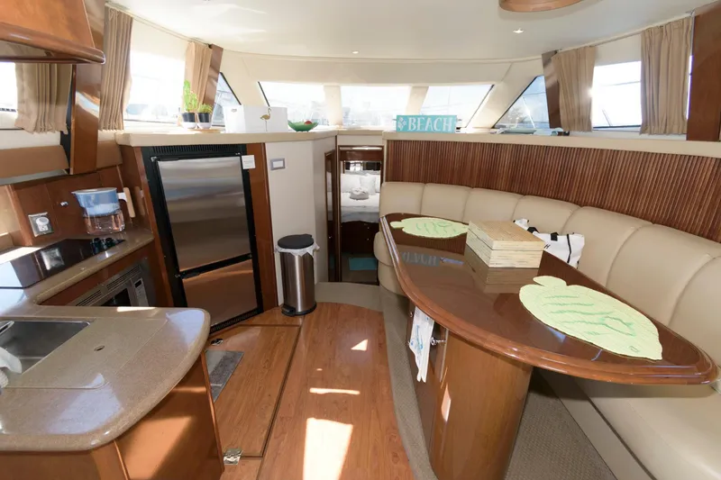 Slide: The Image of Interior of 2007 Carver 42 Super Sport yacht with modern kitchen and dining area. - 19