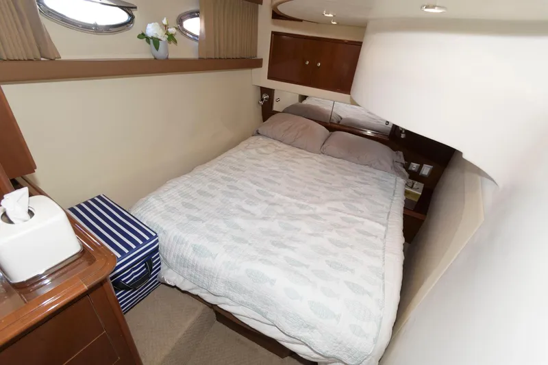 Slide: The Image of Cozy bedroom in 2007 Carver 42 Super Sport yacht with double bed and porthole windows. - 23