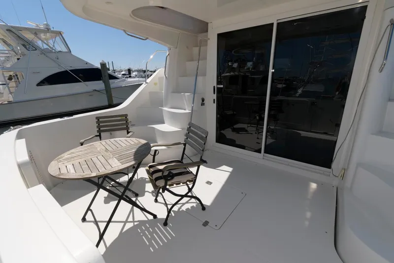 Slide: The Image of 2007 Carver 42 Super Sport yacht deck with table and chairs. - 4