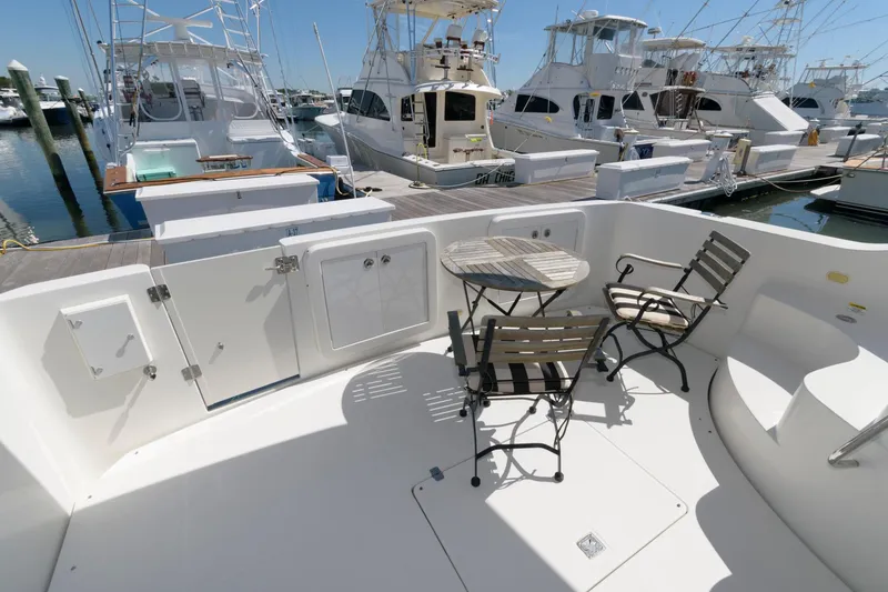 Slide: The Image of 2007 Carver 42 Super Sport yacht deck with chairs and table at marina. - 5