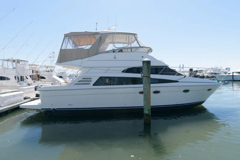 Slide: The Image of 2007 Carver 42 Super Sport yacht docked at a marina. - 1
