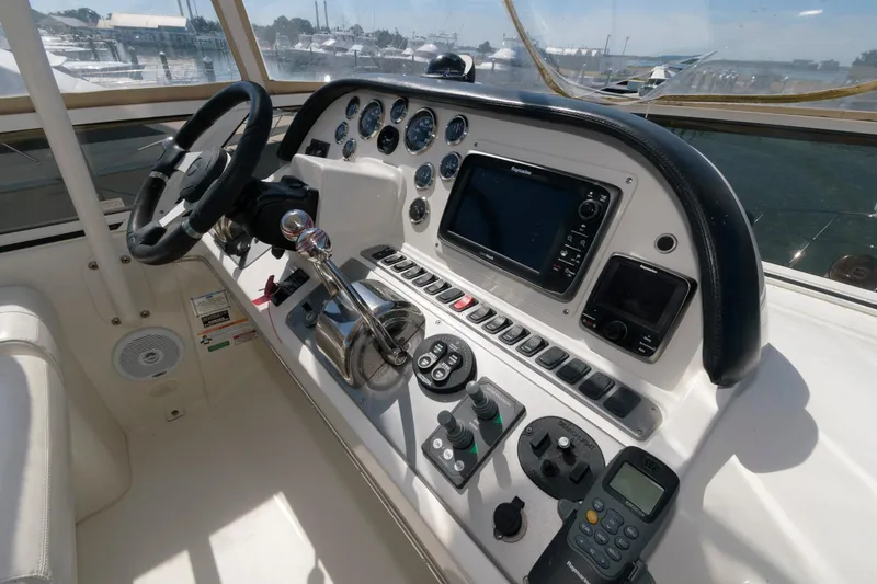 Slide: The Image of 2007 Carver 42 Super Sport yacht helm with navigation controls and steering wheel. - 10