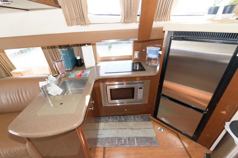 Slide: The Image of 2007 Carver 42 Super Sport yacht kitchen with stainless steel appliances and modern amenities. - 18