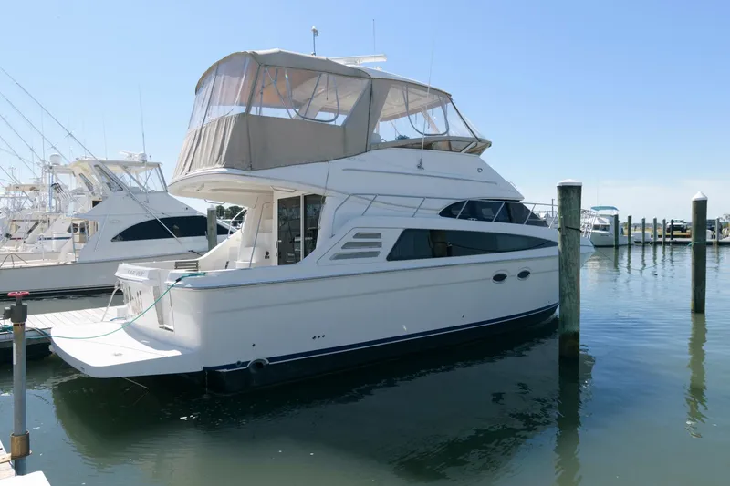 Slide: The Image of 2007 Carver 42 Super Sport yacht docked at a marina. - 2