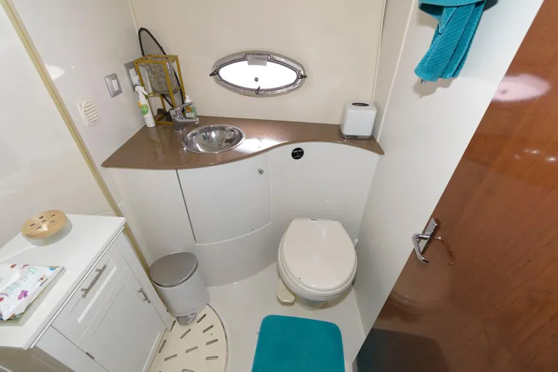 Slide: The Image of 2007 Carver 42 Super Sport yacht bathroom with sink, toilet, and storage. - 24