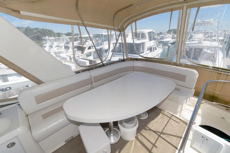 Slide: The Image of Interior seating area of a 2007 Carver 42 Super Sport yacht with a white table. - 7