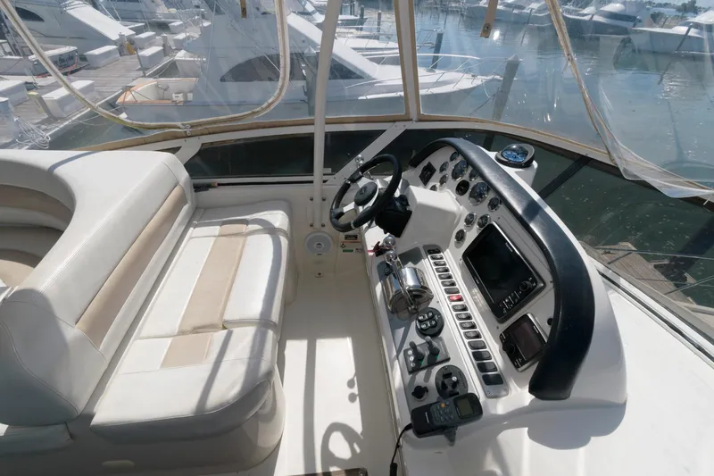 Slide: The Image of 2007 Carver 42 Super Sport yacht helm with navigation controls and seating. - 9