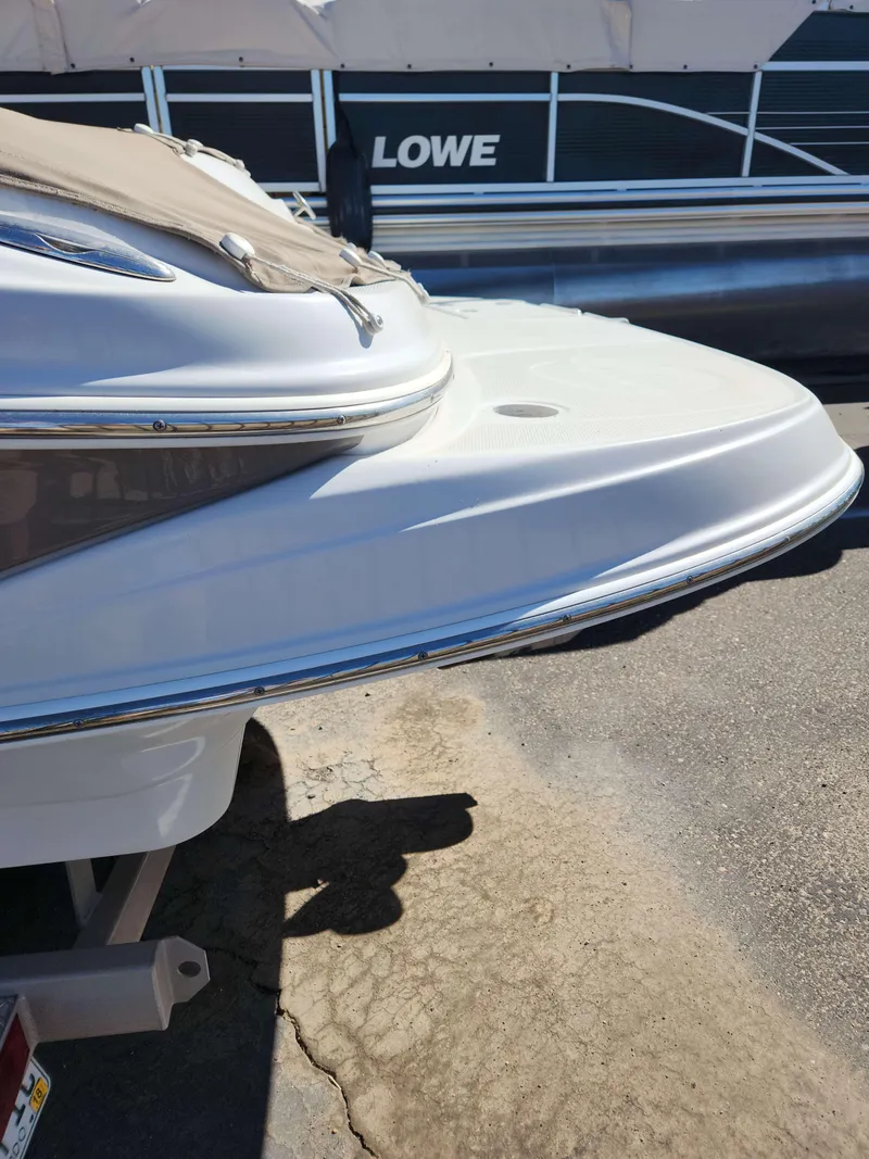 Slide: The Image of 2006 Crownline 230 LS boat with cover, docked beside a Lowe boat. - 11