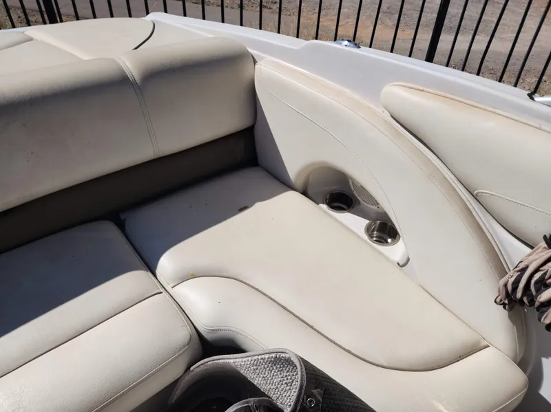 Slide: The Image of 2006 Crownline 230 LS boat interior seating with cup holders. - 6